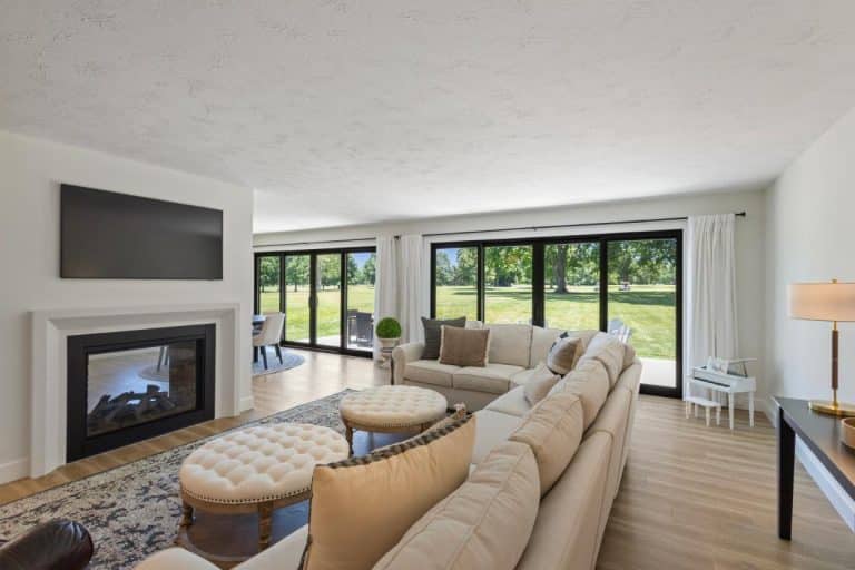 Open living concept with floor to ceiling windows to overlook golf course.